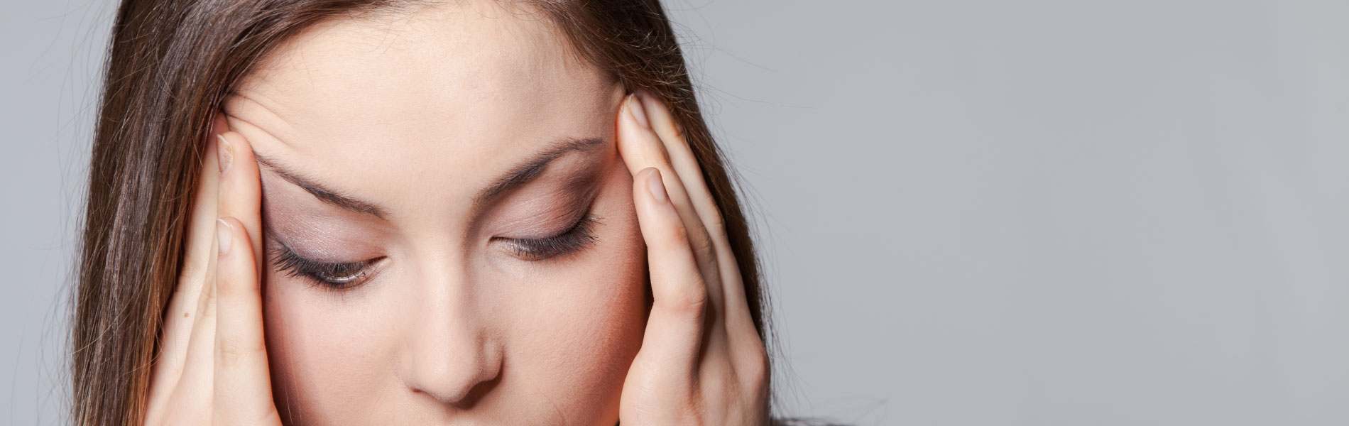 Titan Development Centre | Workplace Training Solutions | Woman rubbing temples